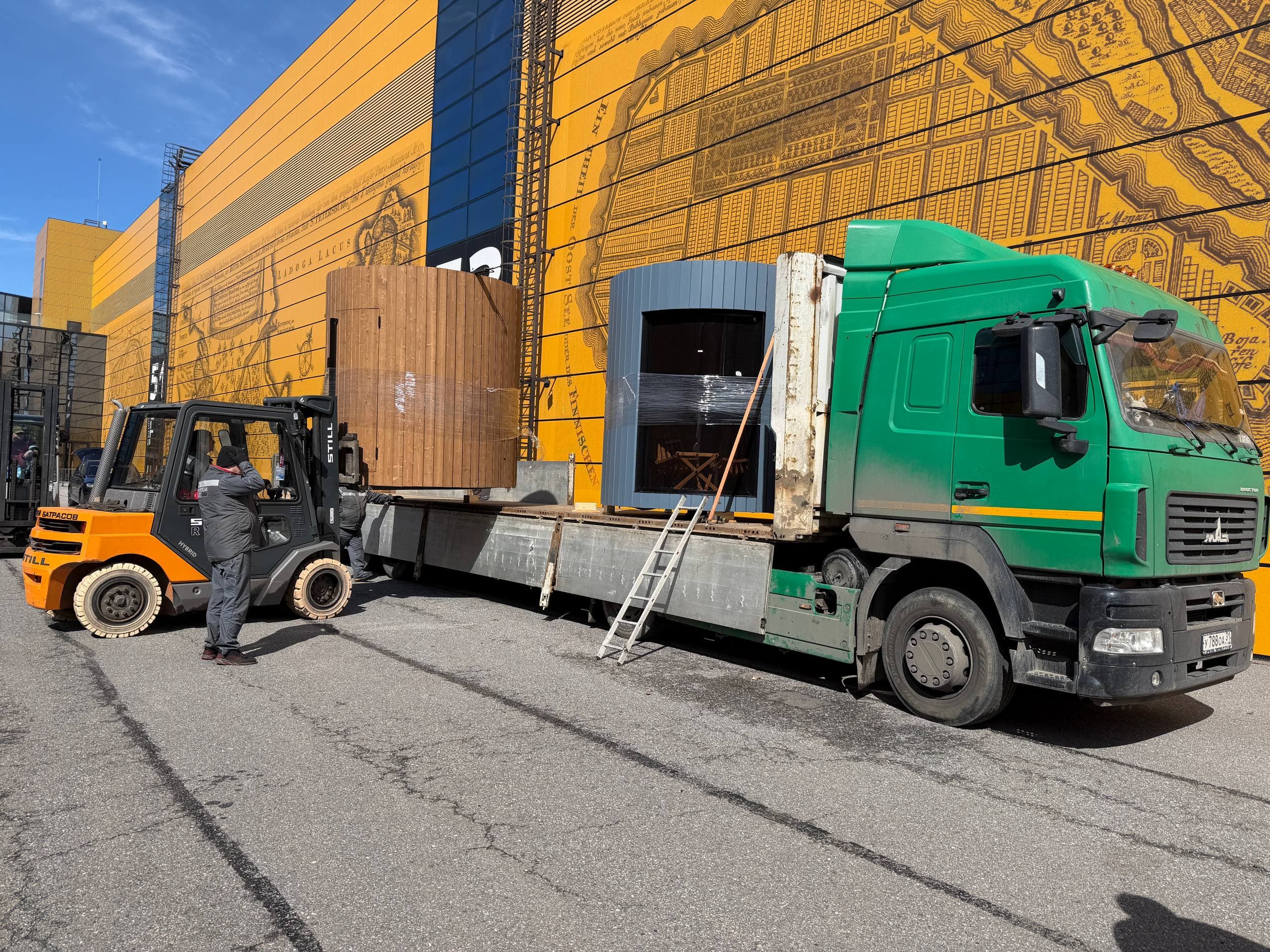 Several finished cylindrical sauna modules on a flatbed truck